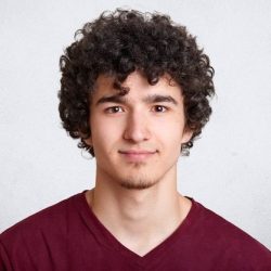 Close up portrait of curly handsome european male _ Free Photo